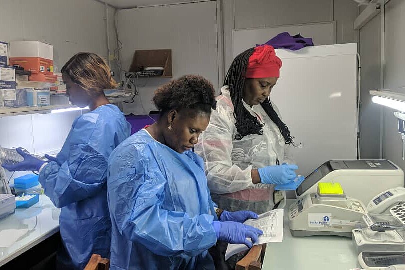 Three women preparing samples in a lab